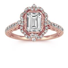 an oval cut pink diamond surrounded by white diamonds in a rose gold engagement ring with halo setting