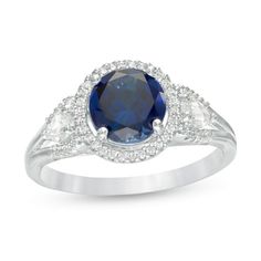 As precious as your beloved, this breathtaking fashion ring shows your appreciation. Crafted in sterling silver, this eye-catching design features a 7.0mm lab-created bright blue sapphire flanked by two 5.0 x 3.0mm pear-shaped lab-created shimmering white sapphires wrapped in a frame of glistening diamonds. Additional diamonds line the split shank. Captivating with 1/5 ct. t.w. of diamonds and a brilliant buffed luster, this style is a sparkling look she's always wished for. This ring is custom- Blue Stone Wedding Rings, Diamond Frame, Three Stone Ring, Ring Displays, Split Shank, Fashion Ring, Sapphire Stone, Three Stone Rings, White Sapphire