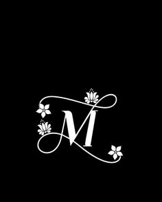 the letter m is decorated with flowers and leaves on a black background, as well as an elegant monogramic font