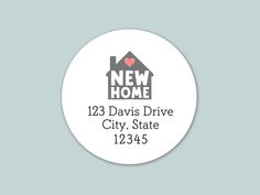 a white round sticker with the words new home on it and a house in the background