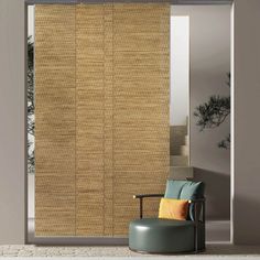 a chair sitting in front of a window covered in bamboo blinds and shades on the sliding glass door