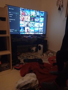 a flat screen tv sitting in a living room next to a book shelf