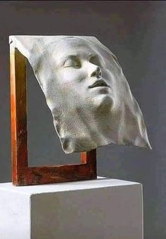 a sculpture of a man's head with his eyes closed