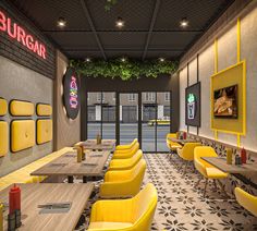 the interior of a restaurant with yellow chairs