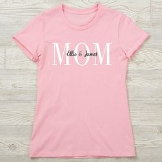 Personalized with 1 line of text  Have her display her family pride in our Mom Personalized Ladies Shirts. A perfect gift for any mom for Mother's Day, a birthday or any special occasion. Personalized Pink T-shirt For Mother's Day, Mother's Day Cotton T-shirt For Family Events, Cotton T-shirt For Mother's Day Family Events, Personalized Pink Tops For Mother's Day, Casual T-shirt For Mother's Day Family Events, Personalized Mother's Day T-shirt With Custom Text, Custom Text T-shirt For Mother's Day Personalized Gift, Custom Text T-shirt For Mother's Day Gift, Mother's Day Family T-shirt With Name Print