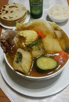 a white plate topped with soup and vegetables