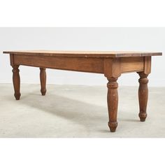 an old wooden table with two legs on the top and one leg extended off to the side