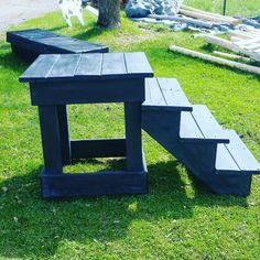 a picnic table and bench made out of pallet boards in the grass next to a tree