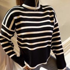 Features: This loose striped turtle neck sweater is the perfect combination of fashion and comfort. The elegant design and warm knit material make it a great option for casual wear. With its relaxed fit and stylish stripes, this sweater is a must-have for any fashion-forward woman. Stay warm and stylish this season with this high-quality pullover. Striped Sweater With Ribbed Collar For Winter, Winter Striped Sweater With Ribbed Collar, Striped Winter Sweater With Ribbed Collar, Trendy Horizontal Stripe Sweater For Winter, Trendy Winter Sweater With Horizontal Stripes, Winter Crew Neck Sweater With Striped Collar, Trendy Horizontal Stripe Winter Sweater, Chic Black Funnel Neck Sweater, Winter Sweater With Striped Collar And Crew Neck