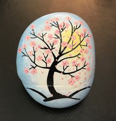 a painted rock with a tree on it