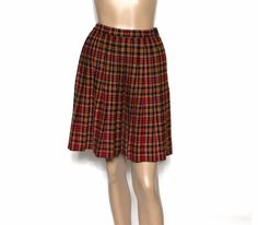 "Okay all you closet bobby-sockers out there, check this cool 1950's skirt out. By \"Minnesota Woolen\" the fabric is 55% orlon acryllic and 45% wool. This box-pleated skirt has a tartan type plaid featuring outstanding colors of red, tan, gold and black. The skirt has a side metal zipper and a top button closure, 1 1/2\" wide waistband and is in excellent vintage  condition.   Measures  W-25\" Hips - Full Overall length of 20\".  Label Minnesota Woole Please ready my shop policies as I don't accept returns.  Should you have any questions please feel free to contact me and I will reply.  If you mark my shop as a favorite you will be able to see my updates." 50s Skirt, 1950s Skirt, Box Pleat Skirt, Vintage Clothing Stores, 1970s Dresses, Full Circle Skirt, 1960's Dress, Rockabilly Dress, Full Circle Skirts