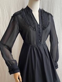 Indulge in timeless romance with this vintage natural silk transparent blouse. Designed with delicate lace and elegant ruffles, this black blouse exudes a retro charm that's perfect for those who love to make a statement. Its lightweight, sheer silk adds a touch of sensuality, while the intricate detailing brings a romantic, feminine flair. Available in sizes S/M, it's a must-have for those who appreciate vintage-inspired elegance with a modern twist. Material: 100% silk, lace 100% cotton, mesh 100% polyester Tag size: 12 (UK), perfect fits S/M Condition: good vintage condition with minimal signs of wear Measurements (laying flat): Shoulders: 39 cm / 15,3" Armpit to armpit: 47 cm / 18,5" Half-Waist: 41 cm / 16,1" Length: 54 cm / 21,2" Sleeves: 59 cm / 23,2" ★A small boutique with unique an Elegant Black Blouse With Ruffles, Elegant Sheer Blouse With Ruffled Collar, Feminine Black Blouse With Lace Trim, Feminine Black Lace Trim Blouse, Feminine Black Ruffled Blouse, Black Feminine Blouse With Ruffled Collar, Vintage Black Blouse With Lace Trim, Vintage Black Blouse With Lace Collar, Elegant Ruffled Lace Blouse