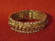 "A Vintage Julio Marsella Rhinestone Gold Tone Charm Mesh Bracelet with Matching Earring Set. Visit our shop for awesome retro photos, vintage jewelry, sports memorabilia and home decor. Size: Bracelet Measures Approx. 7\" long (When Opened) & Earrings Measure Approx. 1\" Material: Gold Tone/Rhinestone Condition: Very Good. Year: 1970's Signed: Signed. Inventory #: 2079" Vintage Rhinestone Jewelry For Gifts, Vintage Bling Jewelry For Party, Retro Jeweled Wedding Jewelry, Vintage Gold Jewelry With Rhinestones, Retro Metal Jewelry For Anniversary, Retro Metal Jewelry, Vintage Metal Jewelry With Bling, Vintage Gold Bracelets With Sparkling Details, Vintage Gold Bracelets With Bling