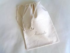 a white bag with embroidered name on it