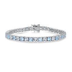 Refresh your jewelry collection with this gemstone tennis bracelet. Perfect for everyday wear, this sterling silver bracelet features 21 blue and white topaz gemstones in an alternating pattern. It can be worn by itself or stacked with other bracelets that best express your individuality. The bracelet measures 7.25 inches in length and 4mm in width. Engagement Ring Guide, Wedding Day Jewelry, Brown Gemstone, Imperial Topaz, Topaz Gemstone, Tennis Bracelet, Ring Size Guide, White Topaz, Diamond Studs