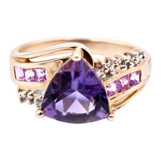 Designer: custom design Material: 10 karat yellow gold Gemstones: Amethyst = 2.12ct Trillion Certification: AGI 25348 Diamonds: .015cttw Color: H Clarity: SI2 Ring Size: 7.5 (please allow two additional shipping days for sizing requests) Dimensions: ring top measures 11.14mm X 10.62mm Weight: 4.70 grams Oval Amethyst Ring, Seed Pearl Ring, Amethyst And Diamond Ring, Yellow Gold Diamond Ring, Gold Diamond Rings, Gold Fashion, Amethyst Ring, Pearl Ring, 10k Gold