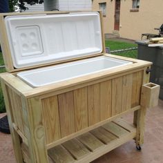 a cooler sitting on top of a wooden cart