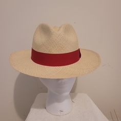 Cream With Red Band Panama Classic Flexfit And Timeless Design Embodies Generations Of Tradition And Authenticity. It Is The Perfect Finishing Touch To Any Look While Providing Protection From The Sun. Handwoven By Expert Artisans With Everlasting Toquilla Straw. Brim Size - 2-3/8” (6cm). Crown Size - 4-3/8” (11cm). Dimension - 13" X 12.5" X 4.5". Lined Internally With 100% Cotton. Features A Fine Polyester And Cotton Headband. Made In Ecuador Adjustable Visor Panama Hat For Kentucky Derby, Flat Brim Toquilla Straw Hats, Toquilla Straw Fedora With Curved Brim, Red Adjustable Hat With Flat Brim, Toquilla Straw Hat With Short Brim, Classic Fitted Visor Hat, Classic Panama Visor Hat For Summer, Classic Visor Panama Hat For Summer, Red Flat Brim Fedora For Vacation