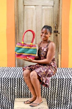 a woman sitting on a bench holding a basket