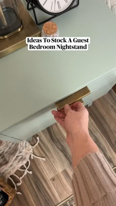 a person is holding the edge of a table with a clock on it and text reads, ideas to stock a guest bedroom night stand