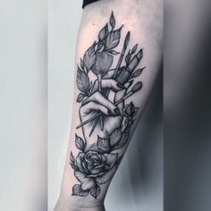 a black and white rose tattoo on the arm