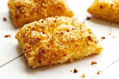 four pieces of pastry sitting on top of a white counter