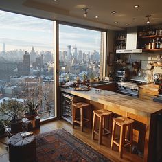 a kitchen with a view of the city from it's high rise window sill