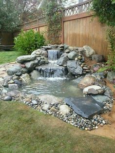 a small waterfall in the middle of a garden