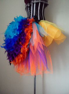 a mannequin with multi colored feathers on it