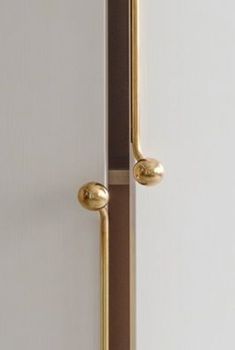 an open door with two knobs on the front and back of it in gold