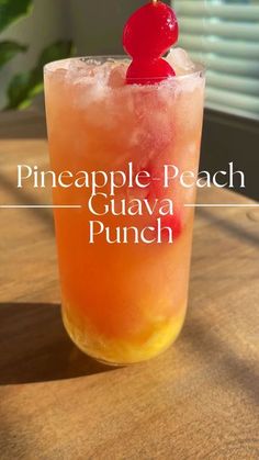 the pineapple peach guava punch is served in a tall glass with a cherry on top