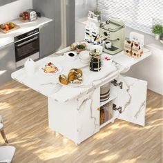 a white kitchen with wooden floors and an island in front of the stove top oven