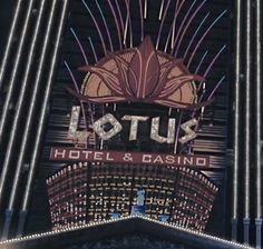 the lotus hotel and casino sign is lit up in red, white, and blue