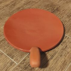 an orange object sitting on the floor