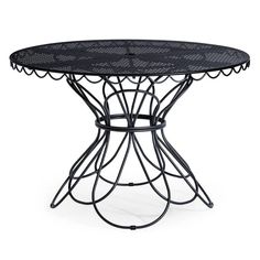 a round table with metal frame and black glass top, on an isolated white background