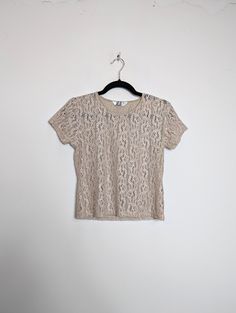 "a vintage beige lacy t-shirt ✿ IMPORTANT INFORMATION: * excellent vintage condition * size: small - please check exact measurements below (they're there for your benefit!) * garment care: machine washable ✿ MEASUREMENTS (taken while item is lying flat, some measurements will need to be doubled): * shoulder to shoulder: 14.5\" (37cm) * armpit to armpit: 16.5\" (42cm) * length (centre of back neckline to bottom): 19\" (48cm) ✿ free UK shipping on orders over £100 with code STRAWBERRY free international shipping on orders over £250 with code LEMON ✿ please refer to measurements and shop policies before purchasing don't hesitate to get in contact if you have any further questions! follow us on instagram for shop updates and promotions: @themarmaladevintage check our shop often: new items are Spring Crew Neck T-shirt With Lace Top, Fitted Lace Top T-shirt With Crew Neck, Fitted Lace Top Crew Neck T-shirt, Fitted Lace Top T-shirt With Short Sleeves, Fitted Lace Top Short Sleeve T-shirt, Summer Lace Top T-shirt With Crew Neck, Vintage Cream Short Sleeve T-shirt, Spring Lace Top T-shirt With Crew Neck, Vintage Cream Short-sleeved T-shirt