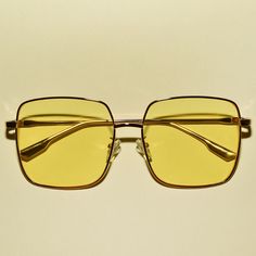 These 1970s vintage style sunglasses feature an oversized square lens, are outlined with a chic gold frame, provide UV 400 protection and comes in multiple colors. Each sold separately. Dimensions:  Length: 6 inches Lens diameter: 2.2 inches Retro Square Frame Metal Sunglasses, Gold Rectangular Sunglasses With Uva Protection, Modern Gold Sunglasses For Spring, Retro Spring Sunglasses With Metal Frame, Retro Gold Sunglasses With Mirrored Lenses, Gold Retro Sunglasses With Mirrored Lenses, Retro Gold Sunglasses For Beach, Vintage Square Frame Sunglasses For Spring, Gold Sunglasses With Uva Protection For Vacation