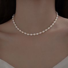 Indulge in the timeless elegance of our Pearl Necklace Choker, a delicate piece that exudes grace and sophistication. Crafted with small natural pearls and set on a dainty 925 Sterling Silver chain, this necklace is the epitome of understated luxury. Perfect for bridesmaids or as a bridal accessory, this necklace adds a touch of refined beauty to any wedding ensemble. Its trendy choker style effortlessly complements modern bridal looks, making it a versatile addition to your jewelry collection. Trendy Pearl Necklace, Pearl Necklace Choker, Trendy Chokers, Natural Pearl Necklace, Bridal Accessory, Understated Luxury, Pearl Choker Necklace, Wedding Bridal Jewellery, Modern Bridal