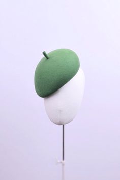 A structured designer beret hand-blocked in grass green bloom felt with elastic to secure in place behind the hair. The hat is designed to be worn on the right side and positioned a finger depth above the height of the right eyebrow Crafted in London using the traditional techniques of model millinery. Berets are universally flattering and their simplicity conveys their understated chic style. Tea Evening, Suzannah London, Pink Veil, London Boutique, Boutique Couture, Silk Shirt Dress, Perfect Cocktails, Beautiful Orchids, Garden Print