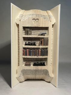 an open book with bookshelves made out of pages and the words love on them