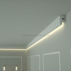 an empty room with white walls and lights on the ceiling is pictured in this image