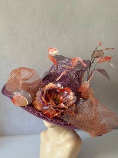 Liana climbs high in beautiful lilac purple and pink metallics. Woven design set on a straw base with beautifully sculpted floral accents makes this hat an over the top stand out piece. Kentucky derby church hat is perfect for any special occasion or event. Inside features elastic headband to allow for a comfortable and adjust able fit. Floral arrangement can be worn to the side or front and center. All designs are made by hand with no two identical. Custom requests are accepted!  This custom straw hat sculpted and designed by milliner, Alyssa Clarenson.  Hat is 18Length x 18 Width x 10" height. * Please note, due to special nature of product and health and safety concerns, returns are not accepted. All items shipped with tracking and insurance, if there is ever an issue, please contact me Purple Short Brim Top Hat For Summer, Fitted Purple Hat For Spring, Elegant Purple Hats For Spring, Elegant Purple Hat For Spring, Purple Wide Brim Top Hat For Summer, Handmade Purple Party Hat, Spring Purple Wide Brim Fascinator, Purple Wide Brim Hat For Spring, Fitted Lavender Hats For Spring