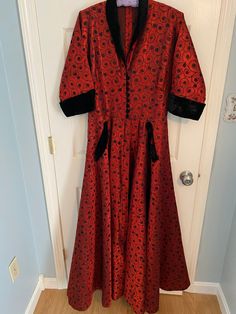 Vintage Taffeta "Lucille Ball" house dress.  Exquisite one of a kind custom made dress.   Deep red with black embroidered like design.  Black velvet color,cuff and bodice buttons.  Concealed front zip skirt.  Extra large flowing skirt.  Shoulder to waist 18".  Waist to floor 41", waist 31", bust 36".   Fits size 10 individual. Fitted Dress With Buttons For Costume Party, Fitted Buttoned Dress For Costume Party, Vintage Full Skirt Costume Dress, Red Festive Costume Dress, Festive Red Costume Dress, Elegant Buttoned Dress For Costume Party, Fitted Full Skirt Festive Dress, Festive Fitted Dress With Full Skirt, Fitted Dress With Full Skirt For Festive Season