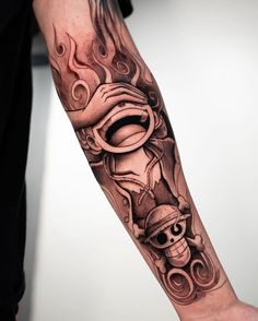 a man's arm with a tattoo on it and a skull in the middle