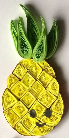 a pineapple made out of yellow and green paper