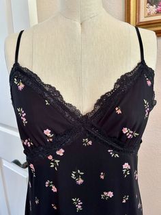 Ready to ship!  NWOT.   Versatile, feminine, comfortable.  Lace bust details.  Adjustable spaghetti straps.  Lettuce hem.  Lining stretches also.  Pair with a denim jacket and flip flops or heels and jewels!   S-T-R-E-T-C-H-Y Size M (medium) Shown on a size 6 dressform. Approx. Measurements: bust: 33 flat, stretches to 40 inches.   waist: 34 flat, stretches to 42 inches.   total length: 46 inches.   Machine Wash Gentle Cold With Like Colors. Non-Chlorine Bleach Only. Line Dry.  About Me: Jillmichelle Artwear Fashion Designer MFA  Wearable art  DM me if you need other design services like alterations and styling, for a separate fee.   I am new to Etsy selling but I have over 250 sales on eBay. References upon request.  Couture bespoke special occasion garments. Emphasizing sourcing, details Black Feminine Sleeveless Camisole, Floral Print Fitted Camisole For Brunch, Black Camisole Dress With Delicate Straps, Black Camisole For Spring Loungewear, Black Camisole With Delicate Straps For Spring, Black Casual Camisole Slip Dress, Fitted Floral Print Camisole For Loungewear, Spring Cami Black Slip Dress, Spring Black Cami Slip Dress