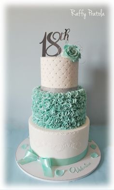 a three tiered cake decorated with blue and white ruffles