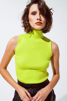 Introducing our Knitted Lime Green Top with a Chic High Neck and Sleeveless Design – a stylish and versatile addition to your wardrobe, perfect for creating fashionable outfits.   Key Features:     Material:  Crafted from a blend of 55% Viscose and 45% Polyamide, this lime green top offers a fine and comfortable knit.   Sleeveless Design:  This top features a sleeveless style, making it versatile for layering under blazers or cardigans.   High Neck:  The high neck adds a touch of elegance and style to your outfit.   Bodycon Fit:  Designed for a body-hugging fit, it enhances your silhouette for a chic and fashionable look.   Turtleneck Neckline:  The turtleneck neckline adds warmth and style to your ensemble, suitable for various occasions.   Fit:  Model is wearing size S. Model is: 32-23-3 Top Without Sleeves, Lime Green Top, Top Verde, Sleeveless Turtleneck Top, Verde Lima, Sleeveless Knit Top, Sleeveless Turtleneck, Turtleneck Top, Green Top