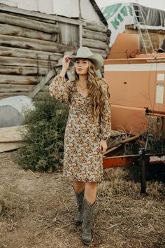 Introducing The Nellie Dress - the perfect fall dress with a midi length that flatters any figure. The charming falling leaf color print adds a touch of nature and the sweetheart neckline and elastic cuffs add a touch of elegance. This western dress is a must-have for your closet! Haylee is wearing size medium paired with Jukebox Boot and Felt Cowboy ProHat Brown Knee-length Midi Dress For Fall, Modest Floral Print Dress For Fall, Fitted Floral Print Midi Dress For Fall, Fall Floral Print Knee-length Midi Dress, Brown Floral Print Midi Dress For Fall, Modest Floral Print Midi Dress For Fall, Knee-length Floral Print Midi Dress For Fall, Fall Floral Print Midi Dress, Mid-length Floral Print Midi Dress For Fall