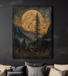 a living room with a couch and large painting on the wall above it that has a full moon in the background